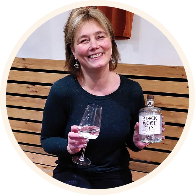 picture of Clare who is the founder of Black Cat Gin tasting one of her special gins.
