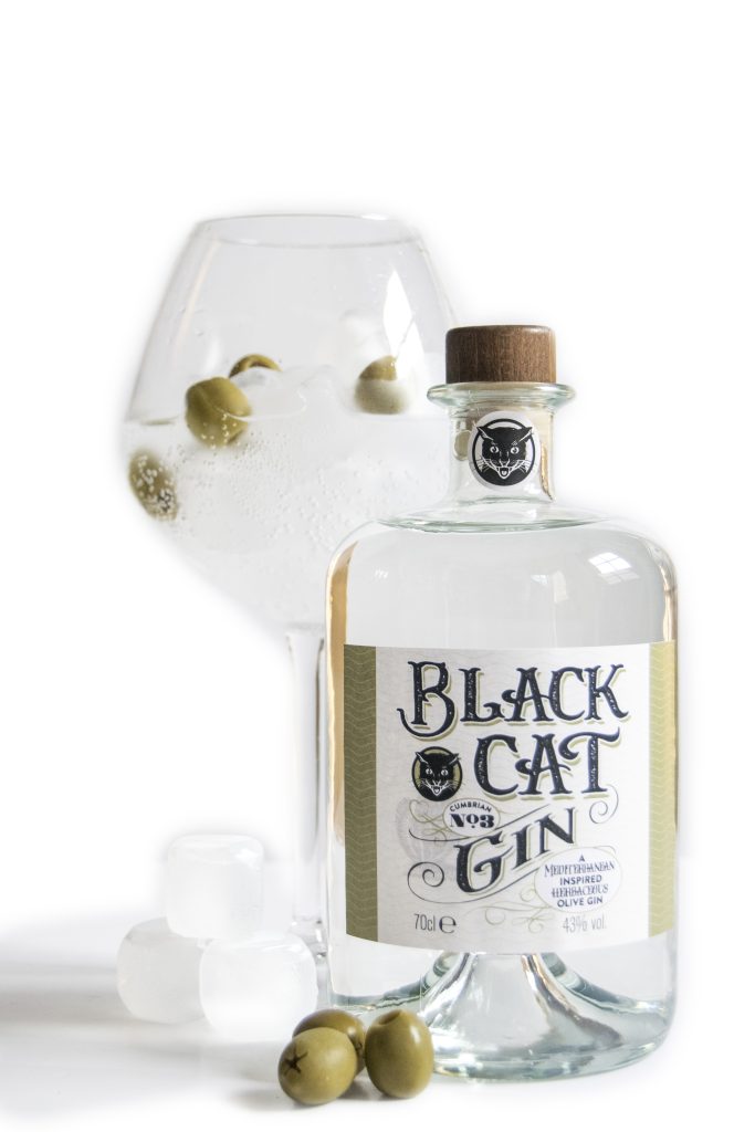 A glass of Black cat Savoury Gin Cumbrian No 3 served with olives